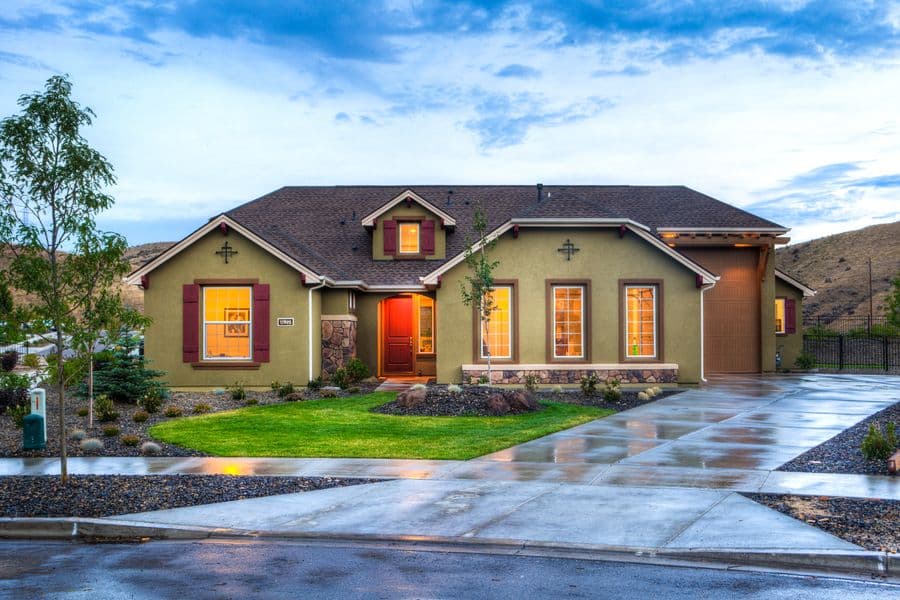 Wide ranch house with a brown shingle roof