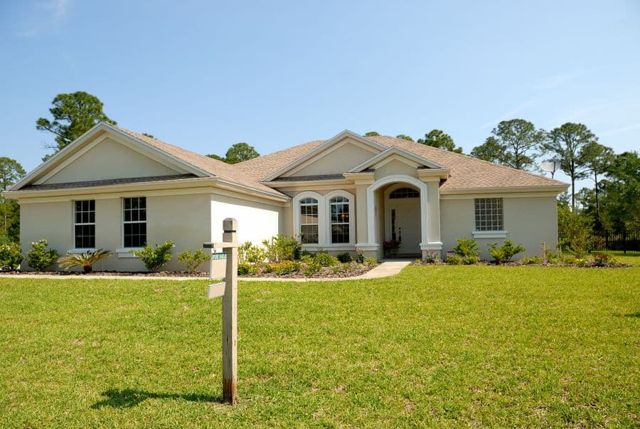 Single-story light stucco house with a hip roof